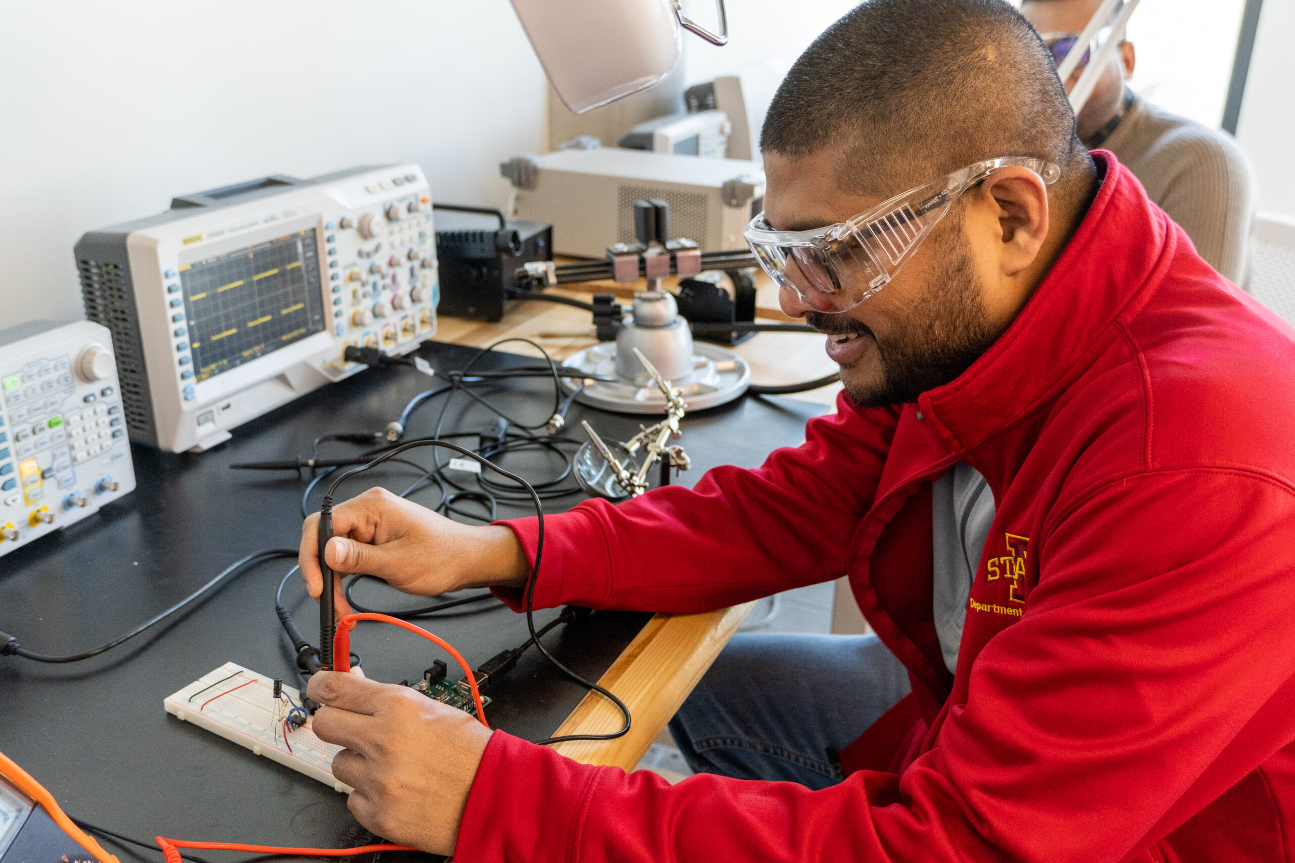 Image of a student soldering components together while wearing protective eyewear.