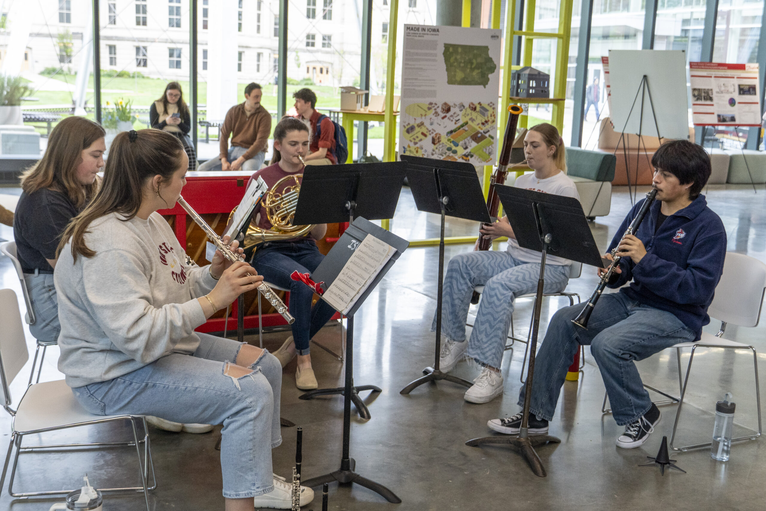 Image of five students demonstrating their innovation through playing musical instruments.